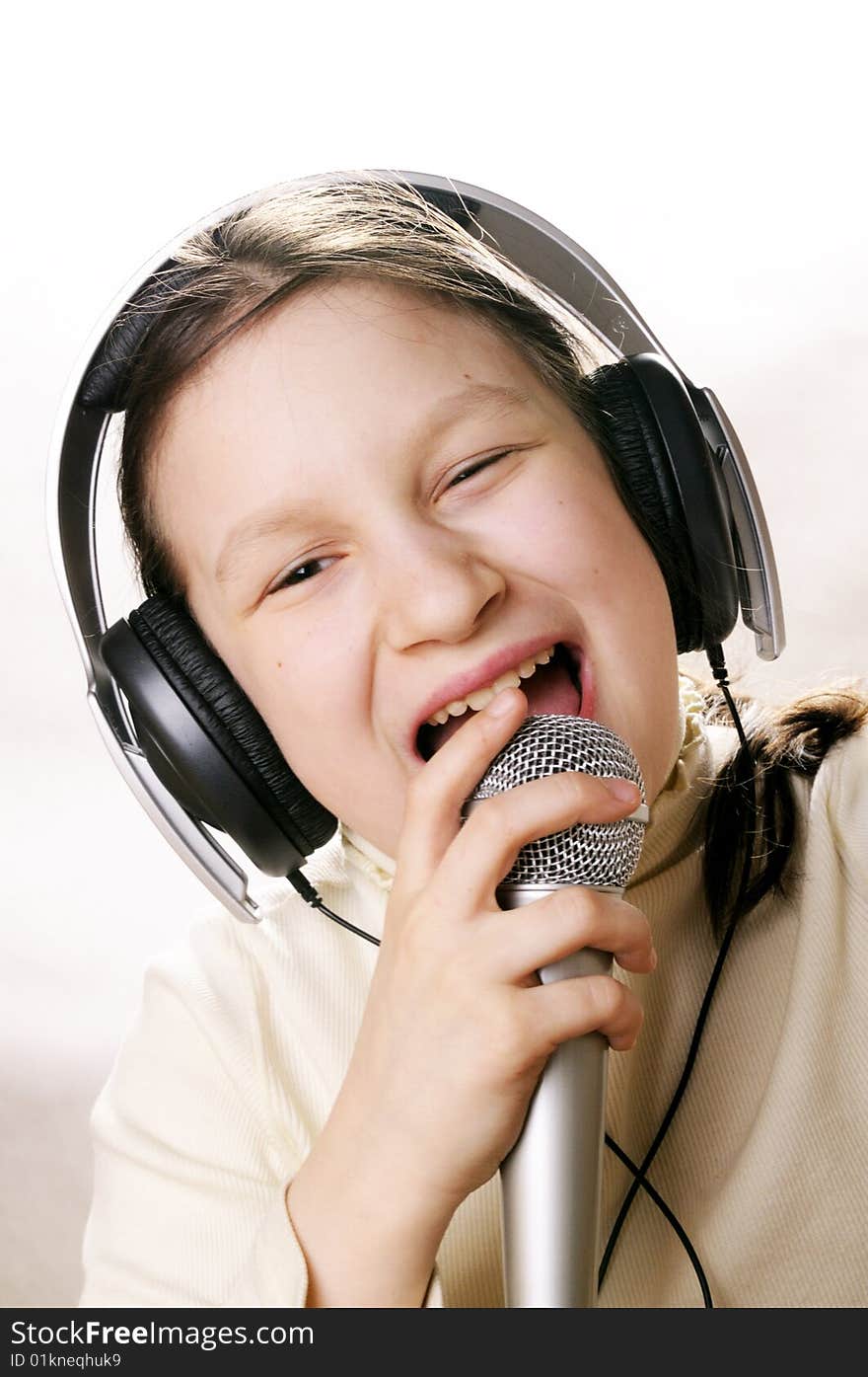 Young girl with microphone singing a song. Young girl with microphone singing a song