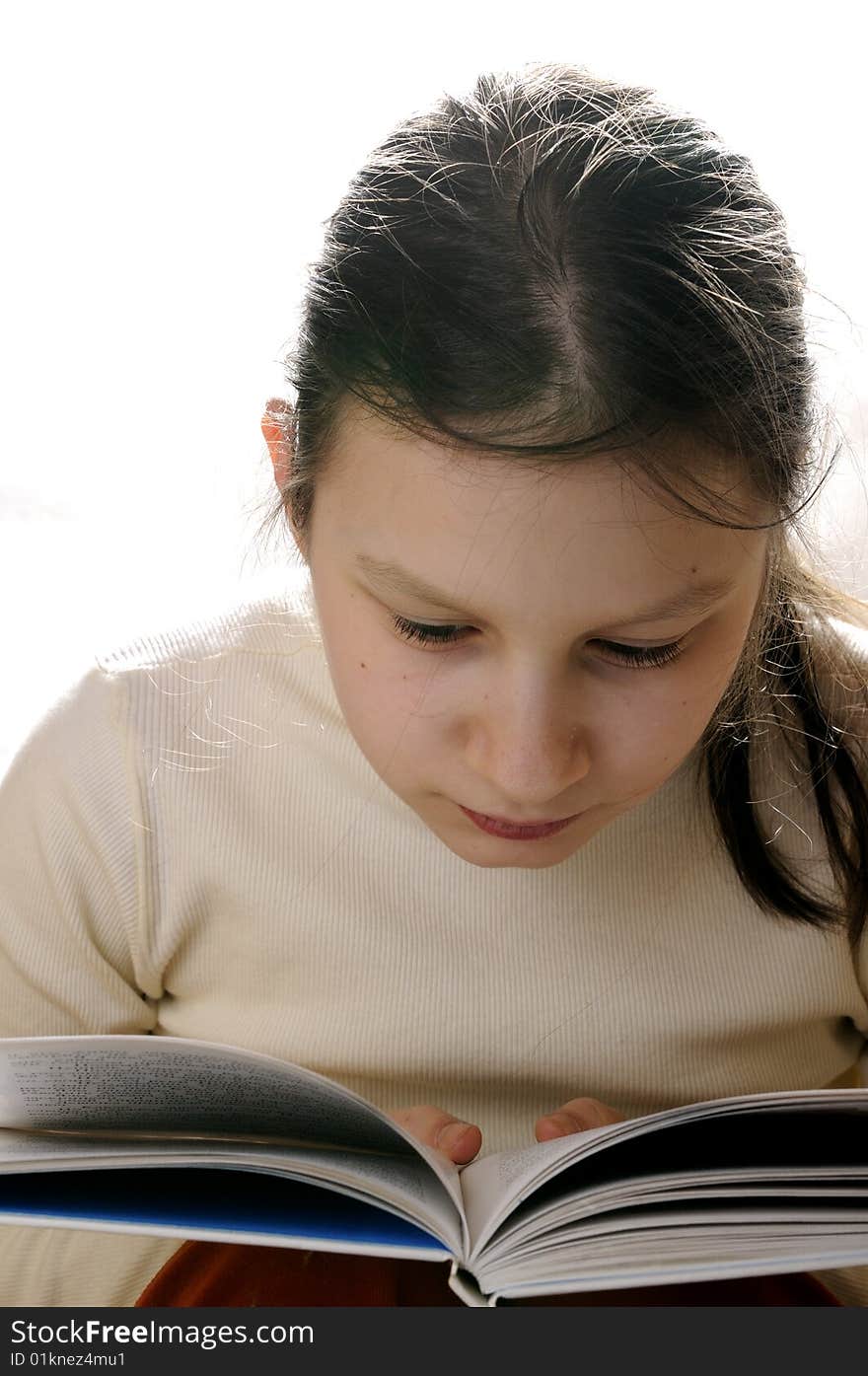 Young girl reading a book