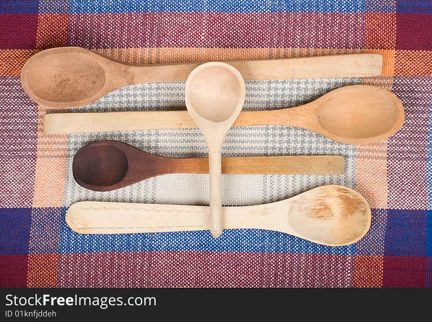 Wooden spoons on a colour sacking. Wooden spoons on a colour sacking