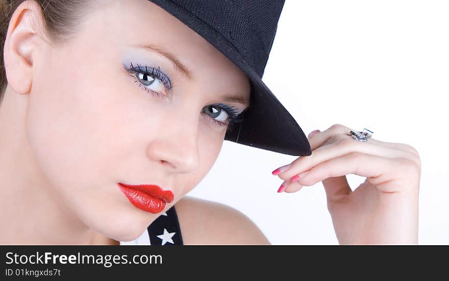 Photo-session in studio of the young blondy girl with black hat