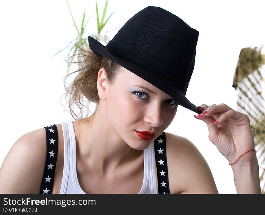 Photo-session in studio of the young blondy girl with black hat