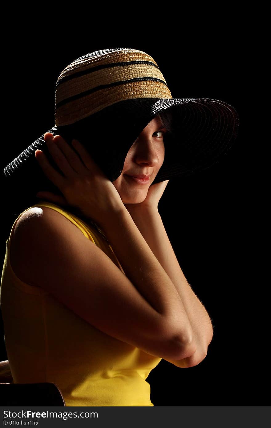 Young brunette girl and straw hat