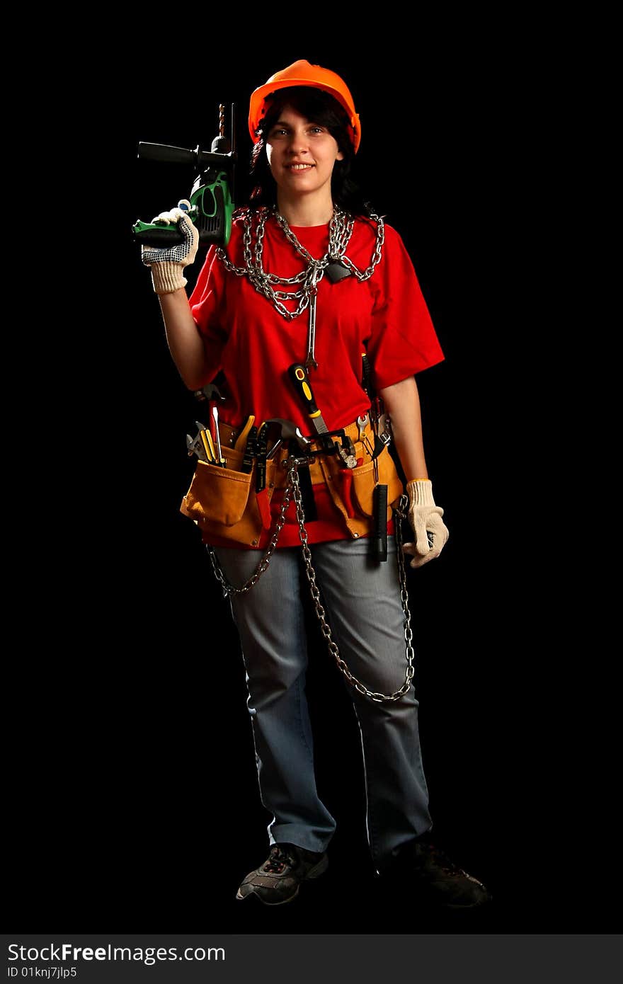 Young woman with work tools and drill, isolated on black