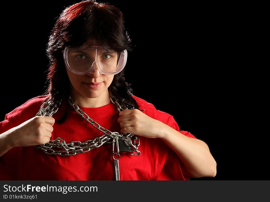 Young woman with chain, isolated on black