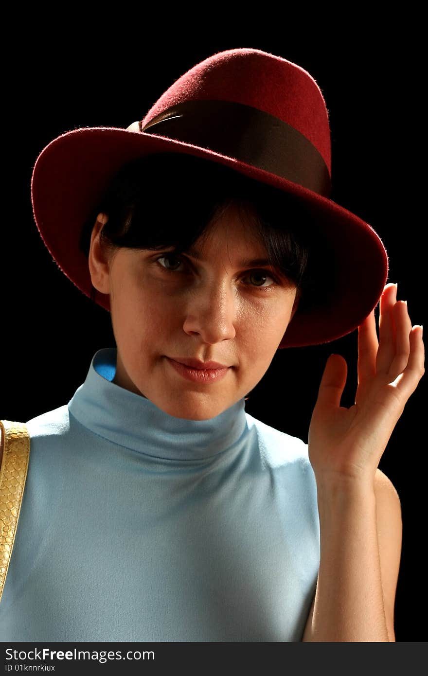 Young woman with red hat, isolated on black