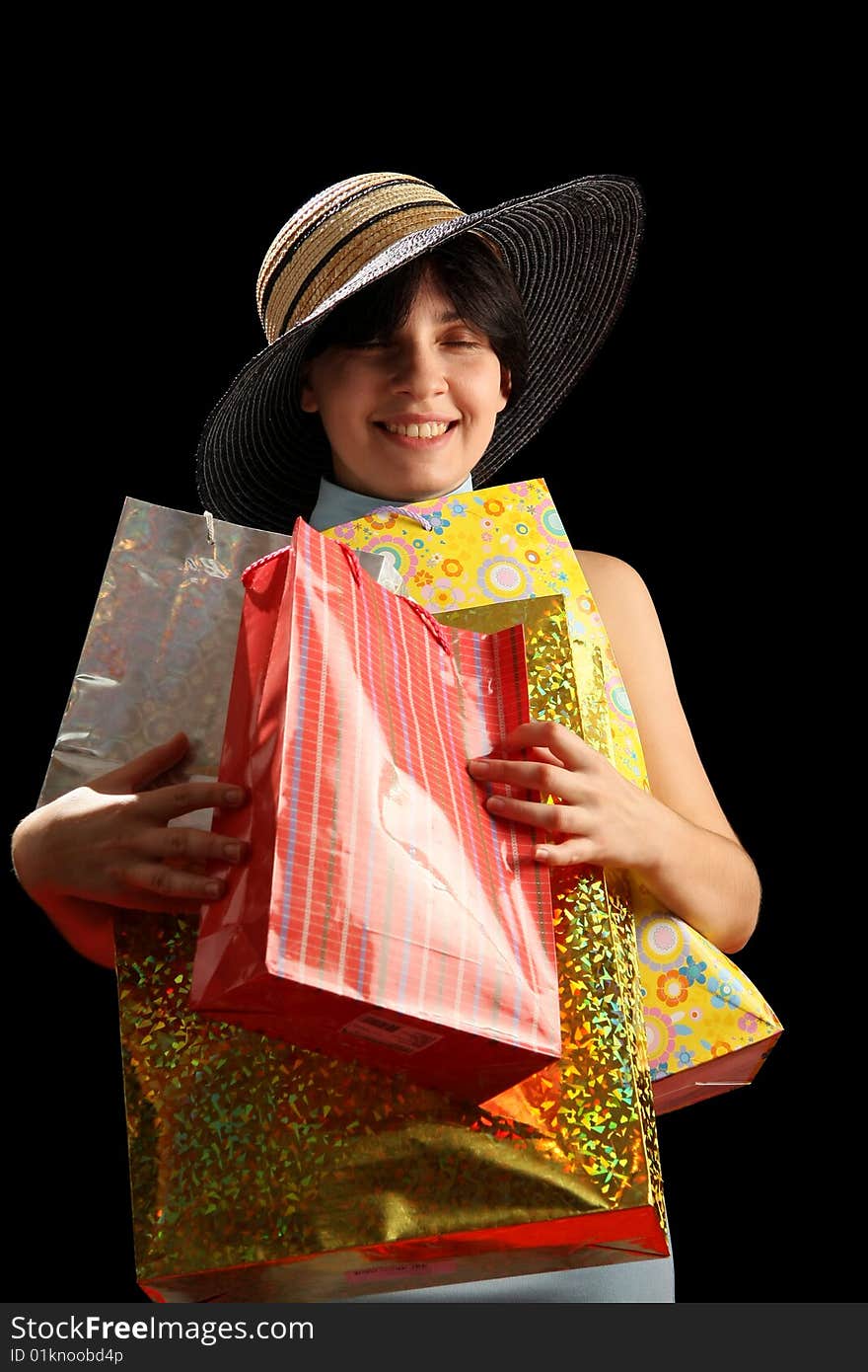 Young woman with shopping bags, isolated on black