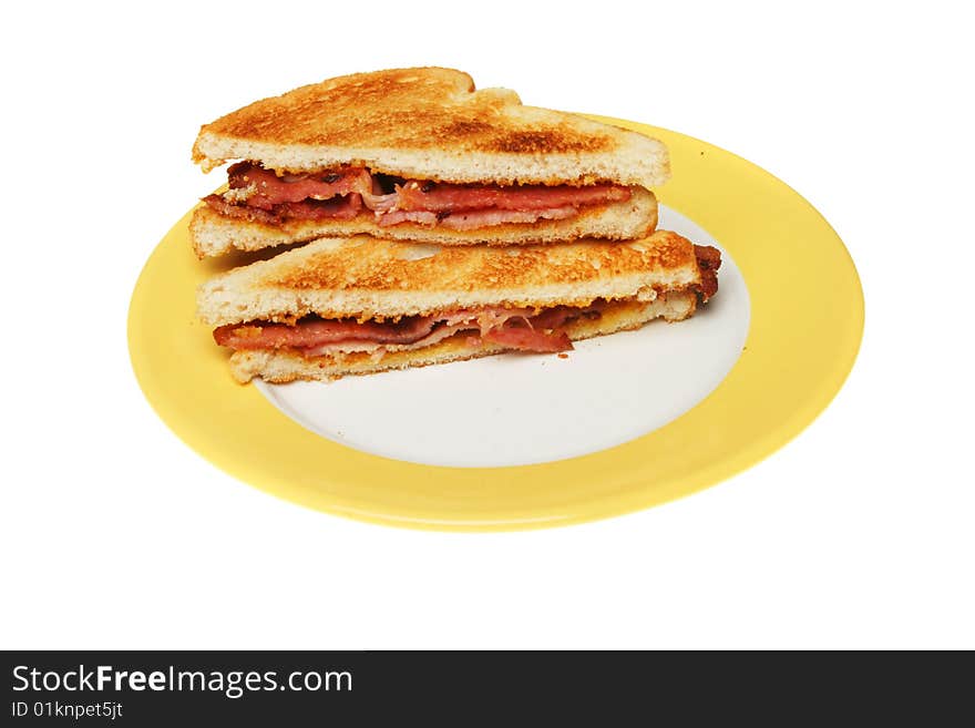 Toasted bacon sandwich on a plate isolated on white