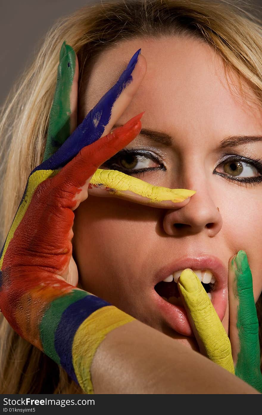 Pretty female model with hands painted rainbow style. Pretty female model with hands painted rainbow style