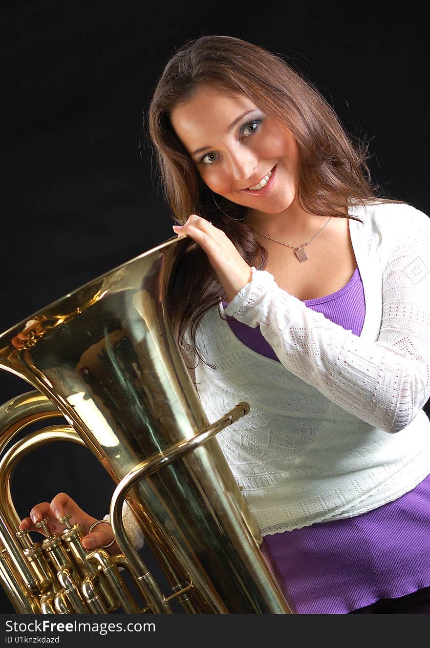 Beautiful girl with her musical instrument tuba.