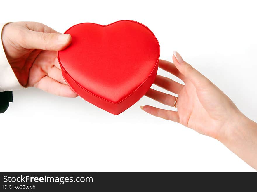 The man's hand gives heart to a female hand. Isolated on a white background. The man's hand gives heart to a female hand. Isolated on a white background