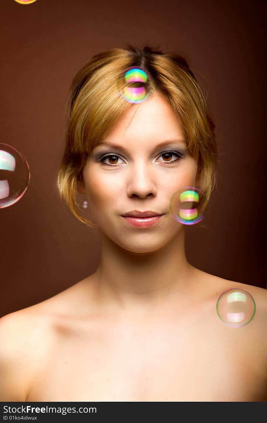 Beauty portrait of a young woman with soap bubbles