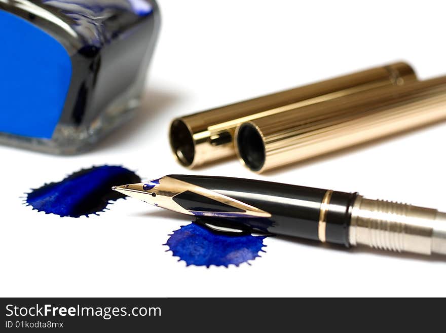 Filling of a golden pen with blue ink isolated on white. Filling of a golden pen with blue ink isolated on white