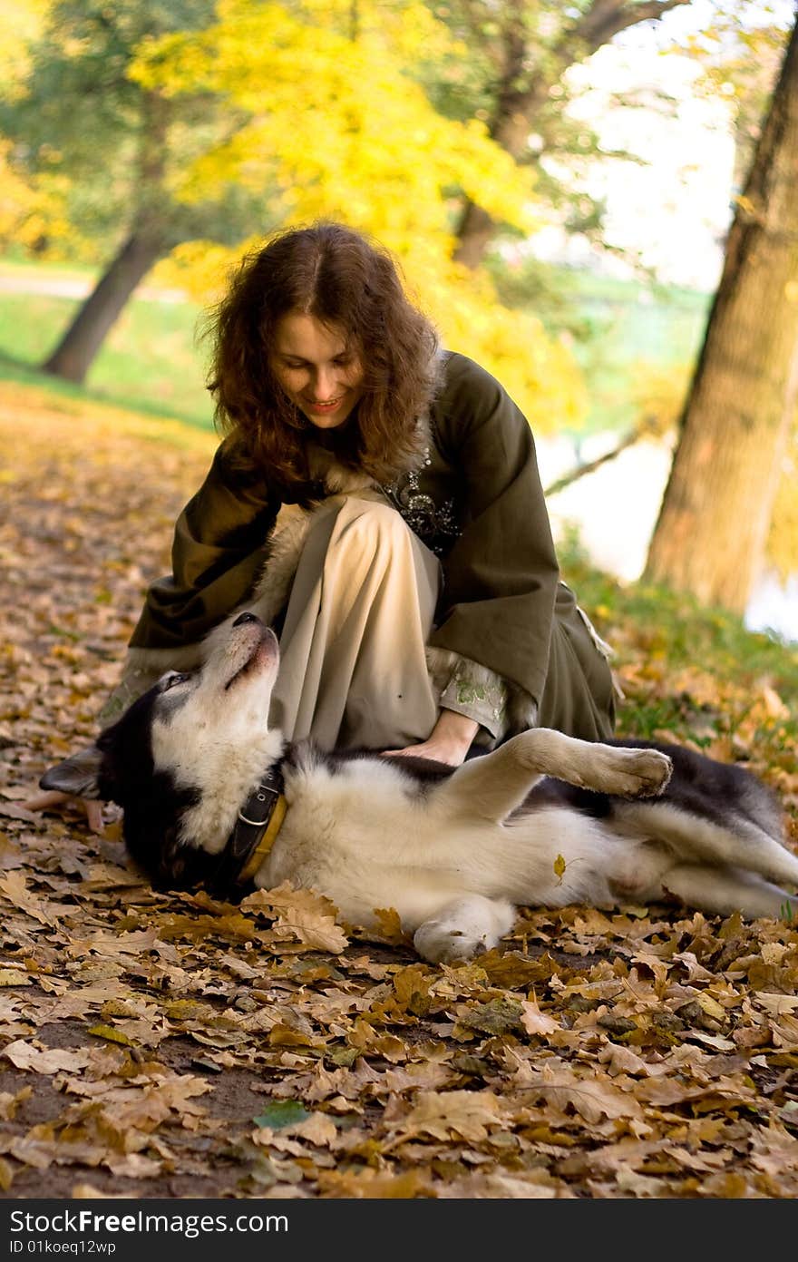 Lady in medieval dress and dog in the forest. Lady in medieval dress and dog in the forest