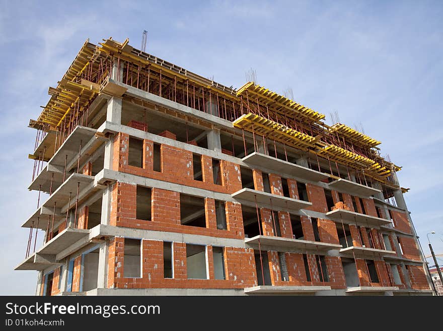 Unfinished building on a site with sky background