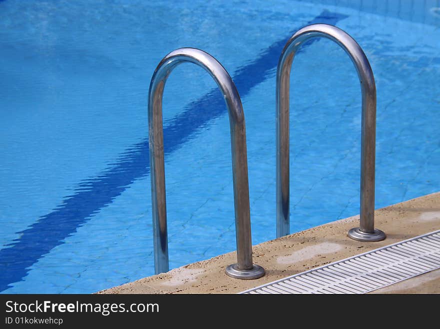 Ladder on hotel swimming pool side. Ladder on hotel swimming pool side