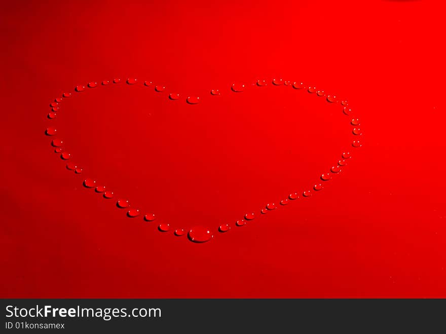 Water drops in the form of heart on a celebratory background