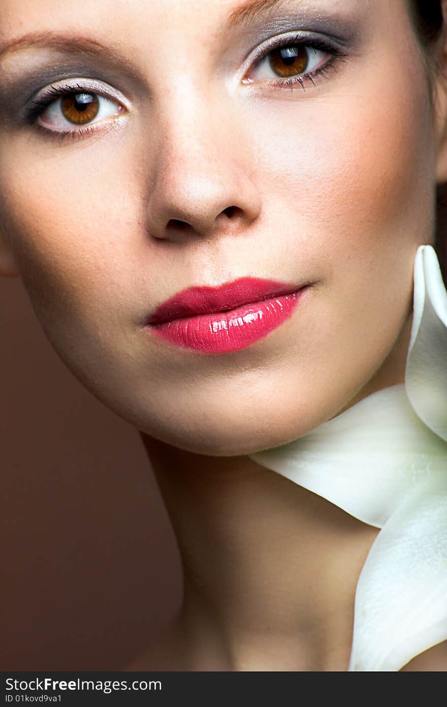 Beauty portrait of a young woman with a lily flower. Beauty portrait of a young woman with a lily flower