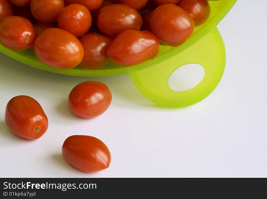 Many Red Tomatoes In The  Green Colander.