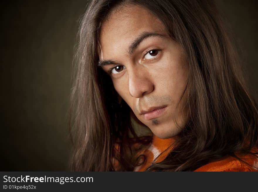 Closeup Portrait of a Handsome Young Man with Long Hair