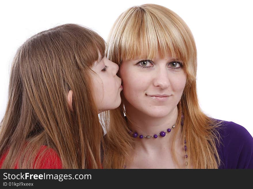 Girl is kissing woman. Daughter's kiss. Daughter kissing her happy mother. Isolated on white in studio. Girl is kissing woman. Daughter's kiss. Daughter kissing her happy mother. Isolated on white in studio.
