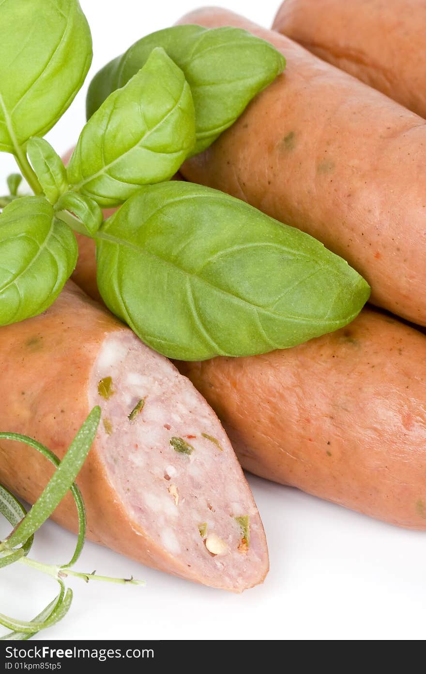 Detail of sausages with basil, rosemary and pepper