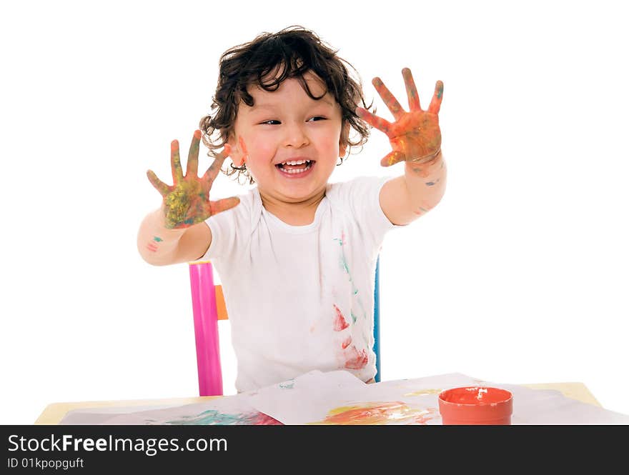 Little boy painting with paints for hands