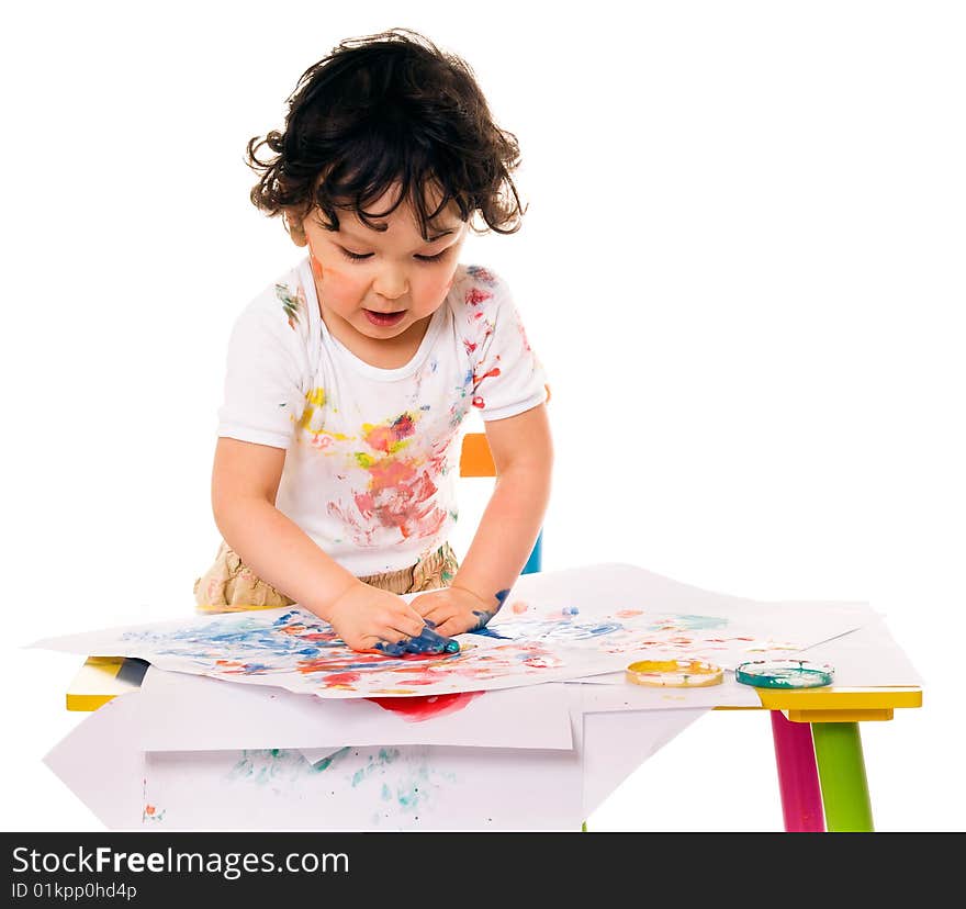 Little boy painting with paints for hands