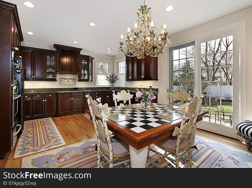 Kitchen and eating area with checkerboard table. Kitchen and eating area with checkerboard table