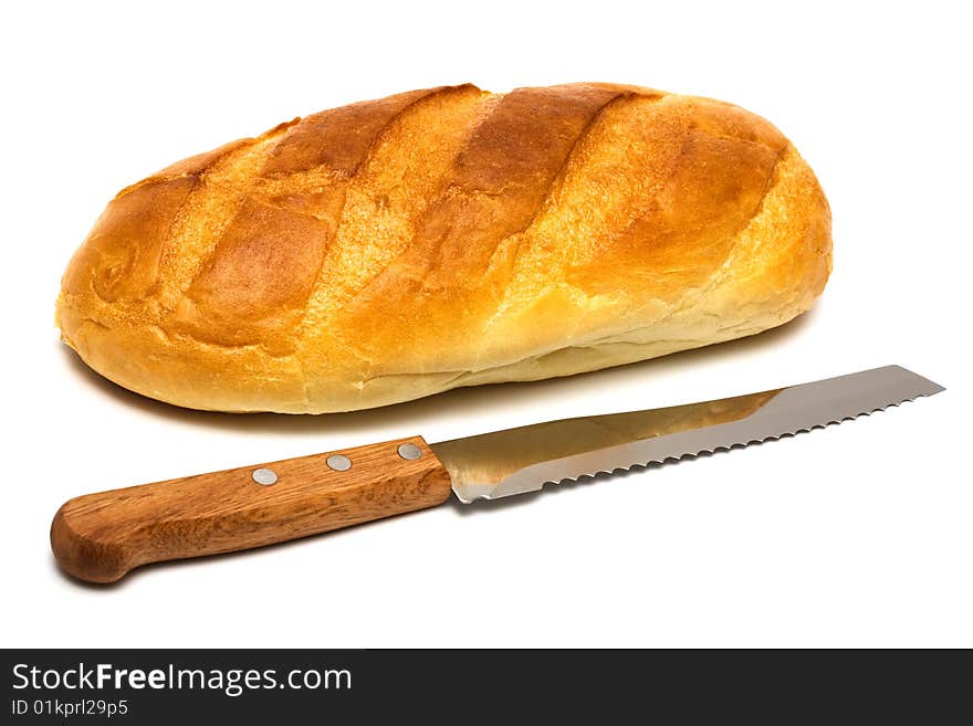 Fresh bread and knife on a white background