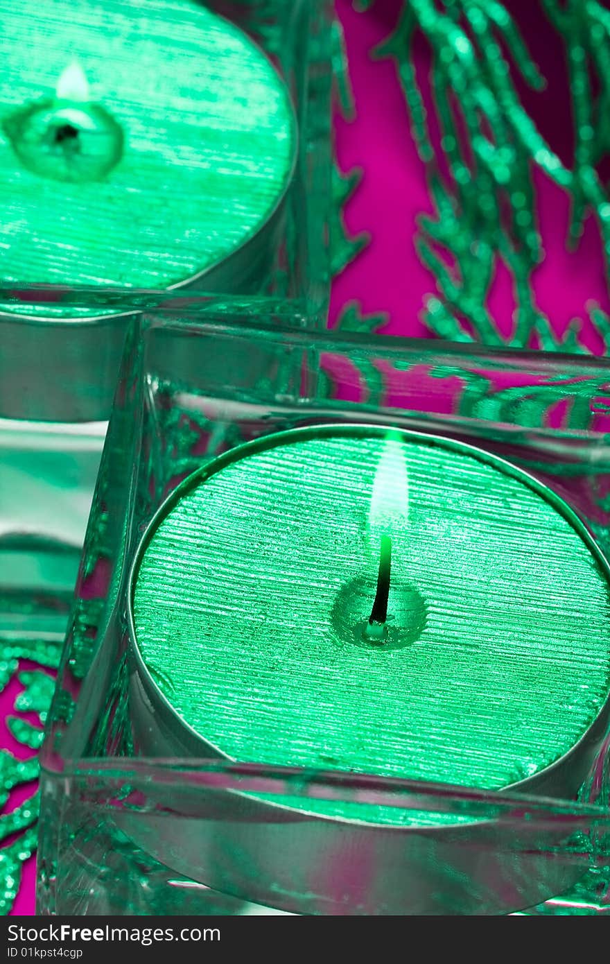 Green candles in glass