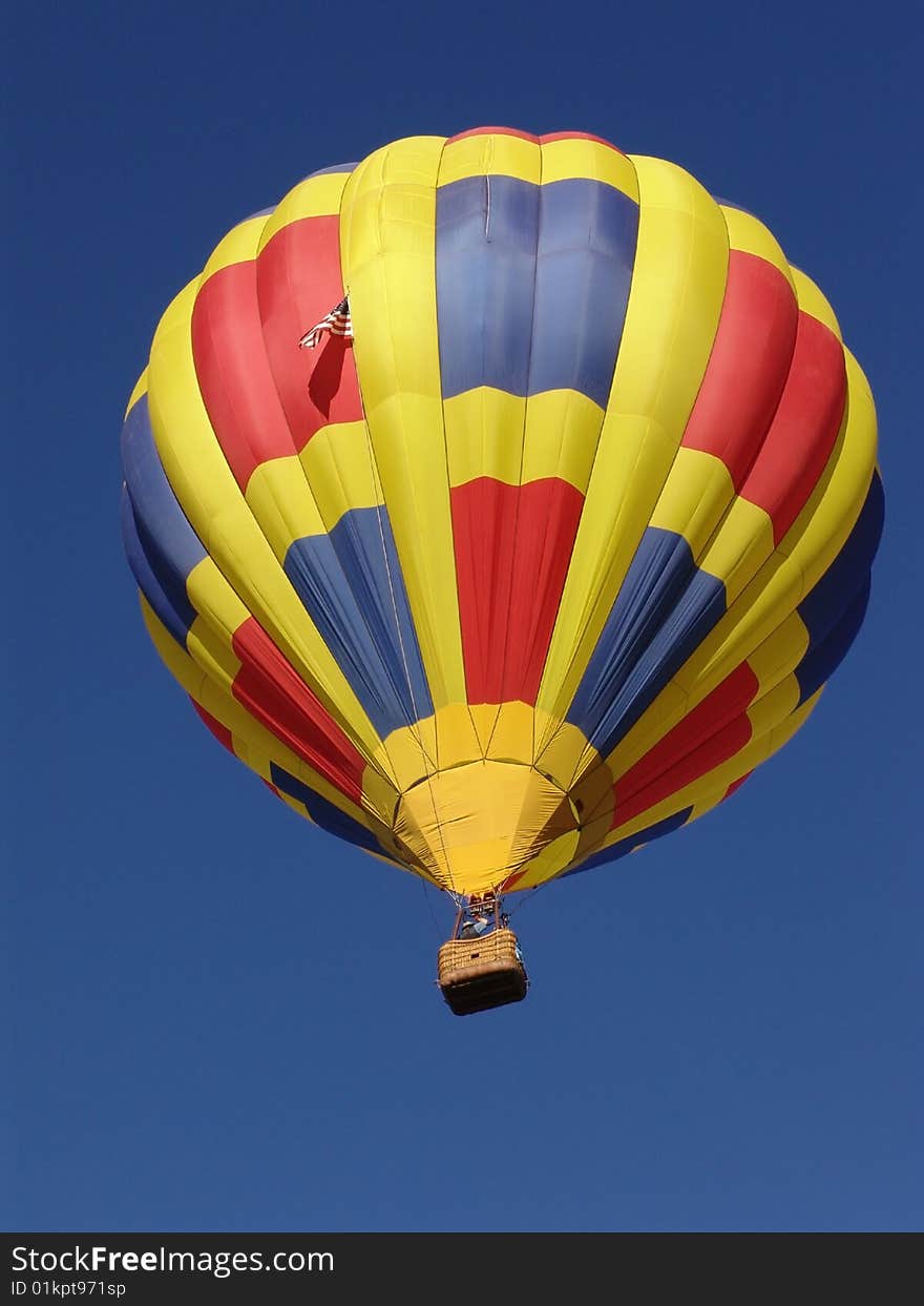 A hot air balloon against the blue sky. A hot air balloon against the blue sky