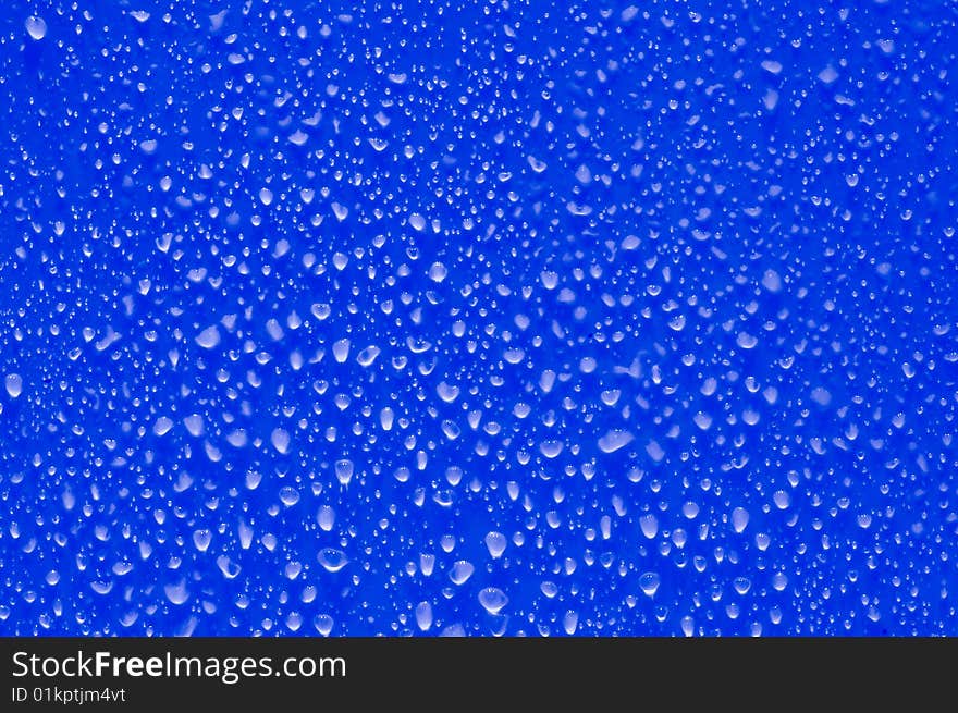 Little drops of water on blue surface. Little drops of water on blue surface