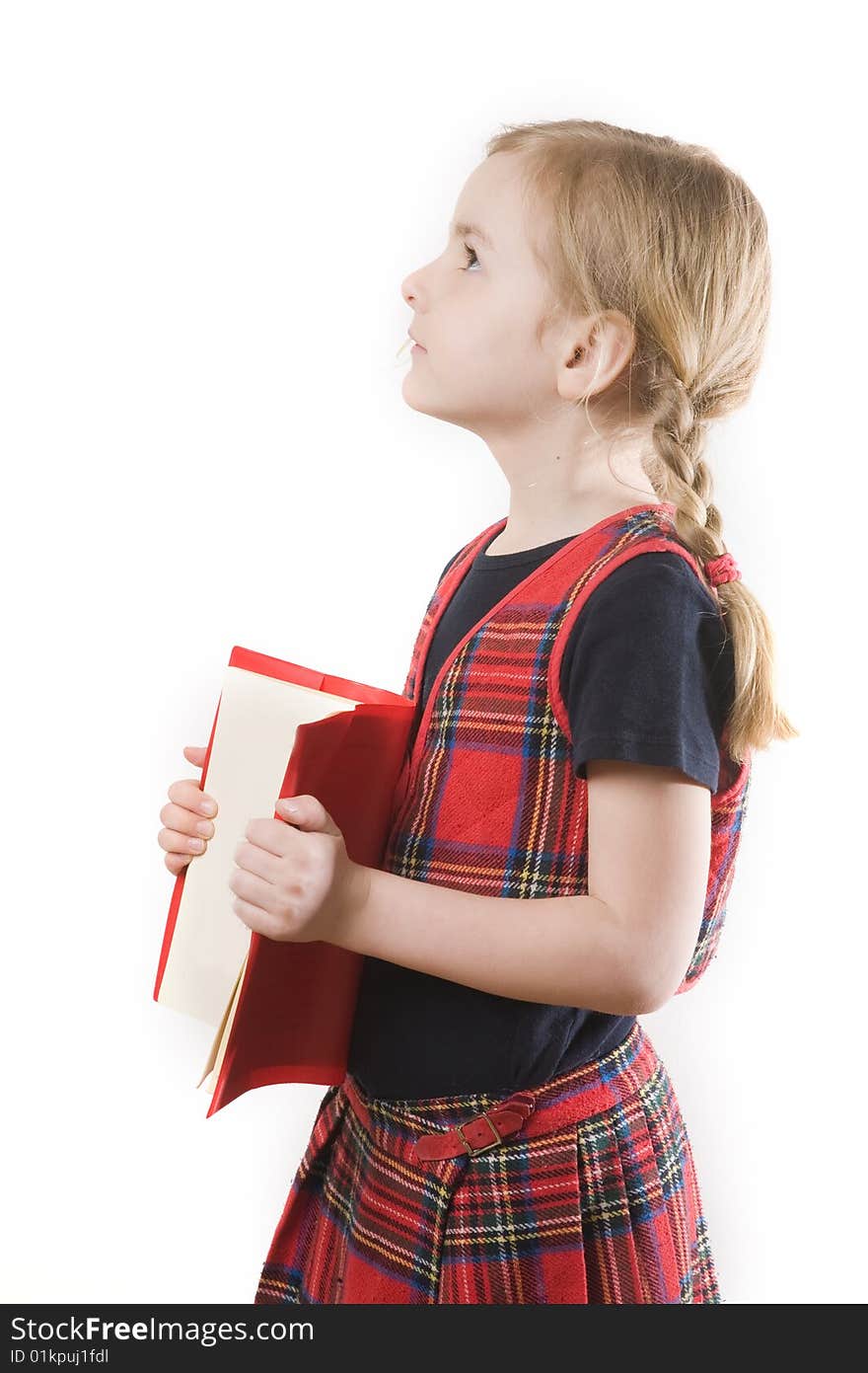 Serious schoolgirl with red book over white. Serious schoolgirl with red book over white