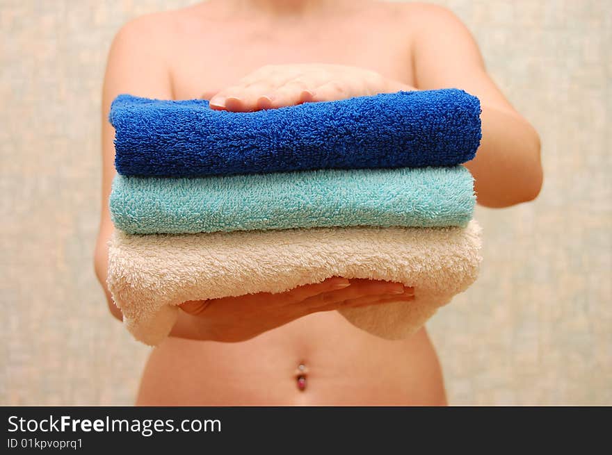 Female hands hold three clap towels