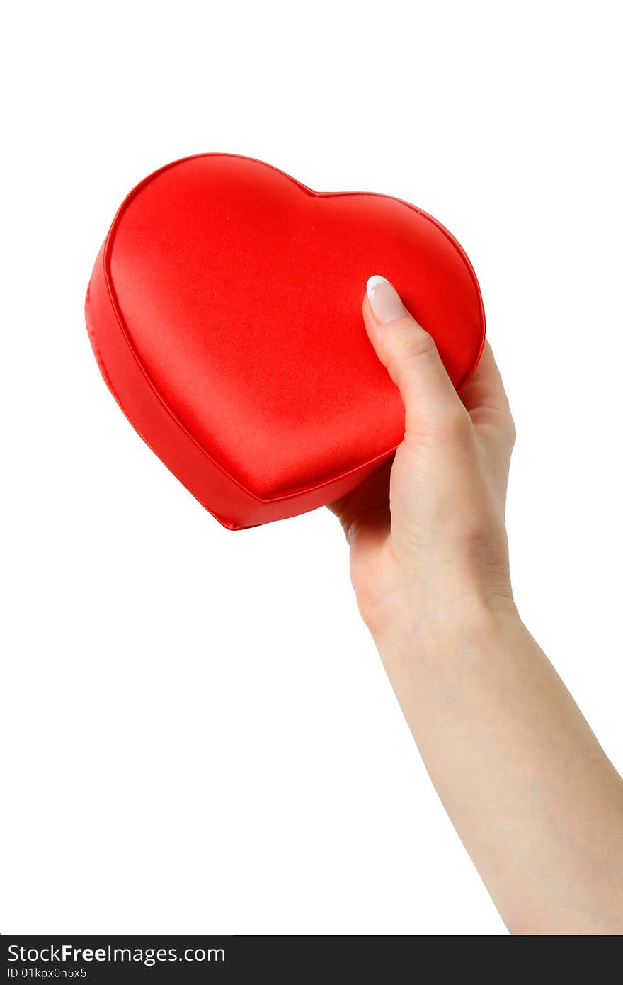 Female hand holding a heart. Isolated on a white background. Female hand holding a heart. Isolated on a white background