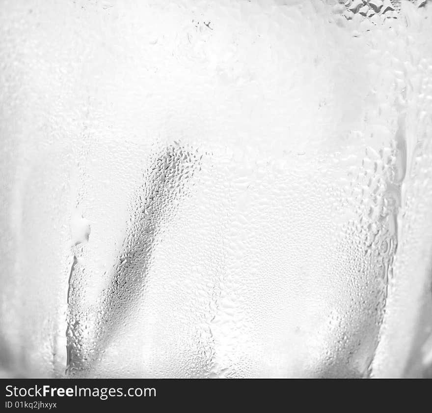 Water drops on glass with ice for background