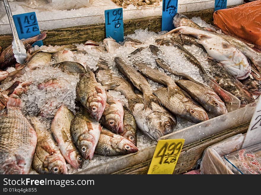 View of whole fresh fish on ice for sale a a market. View of whole fresh fish on ice for sale a a market.