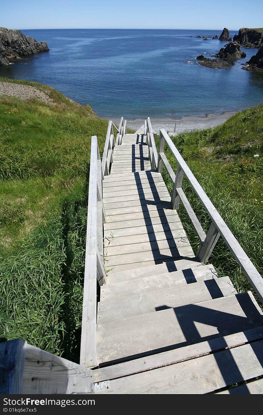 Stairs leading down cliffs to a beach below. Stairs leading down cliffs to a beach below