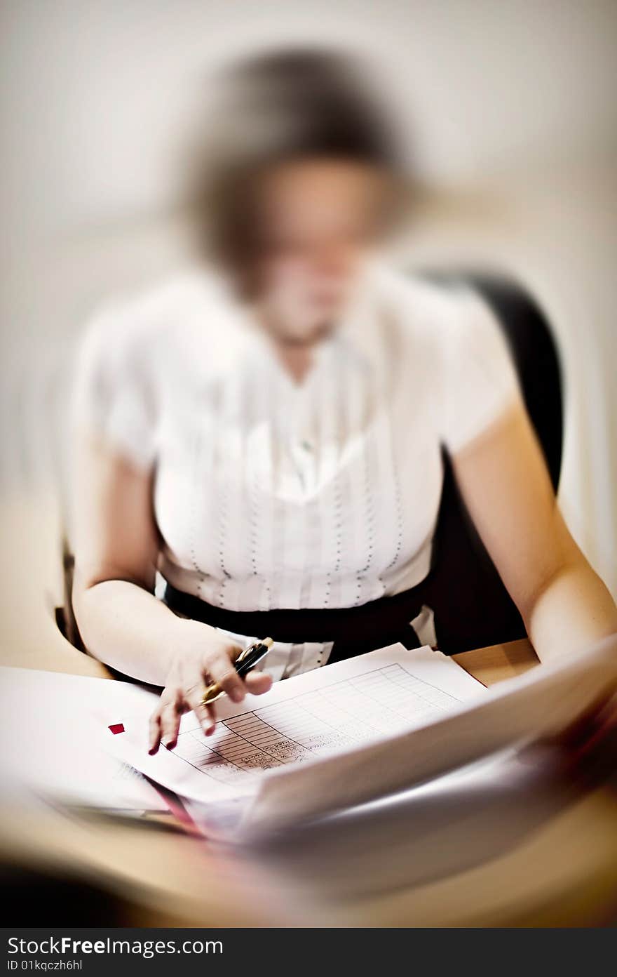 Businesswoman doing Paperwork at Desk. Businesswoman doing Paperwork at Desk