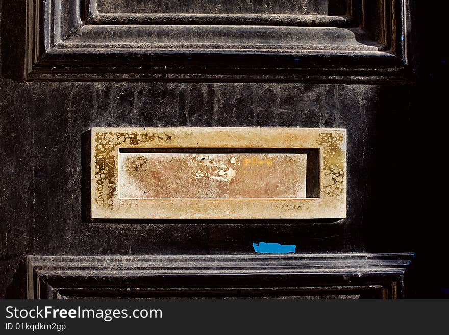 Black door gold worn letterbox