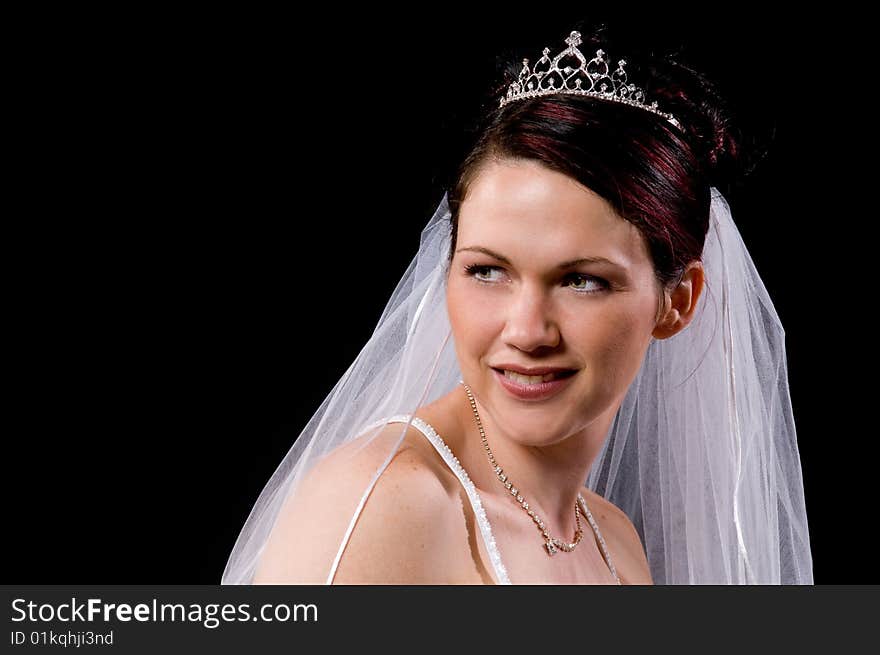 White Bride at her wedding posing with veil