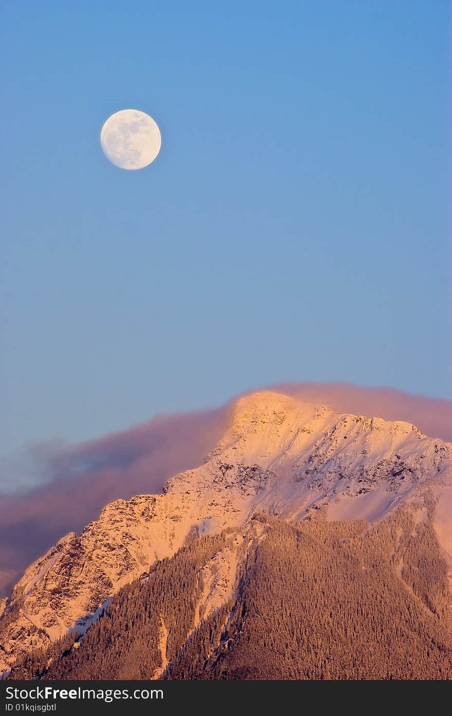 A full moon rises over Mt. Cheam near Chilliwack, BC Canada. A full moon rises over Mt. Cheam near Chilliwack, BC Canada