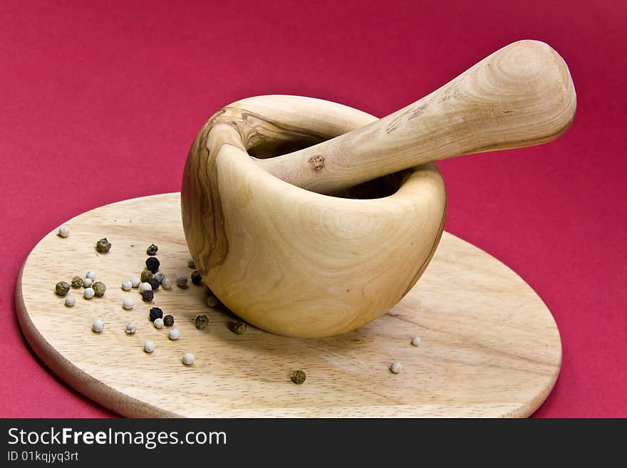 Mixed Pepper Grains on the cutting board with mort