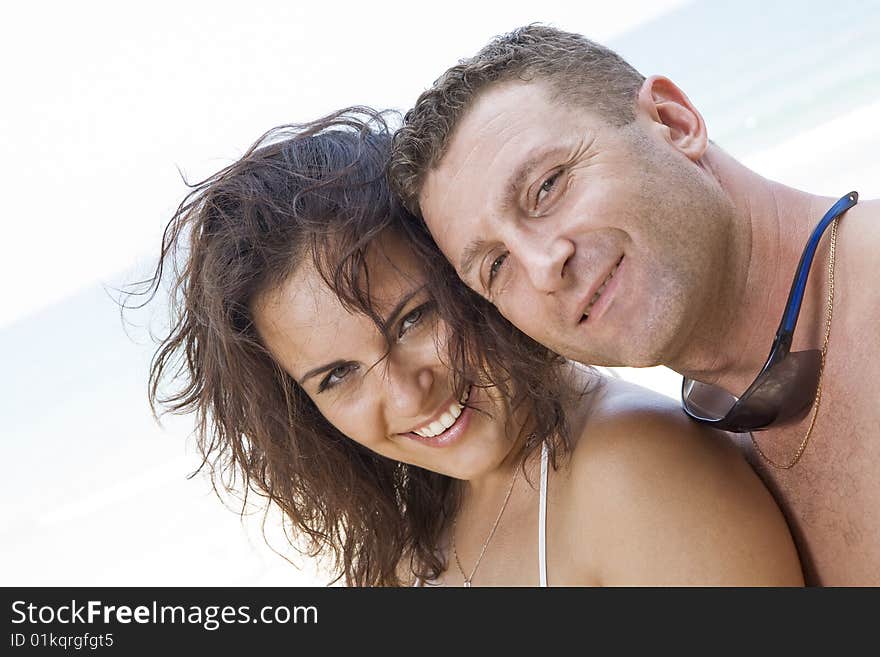 A portrait of attractive couple having fun on the beach. A portrait of attractive couple having fun on the beach