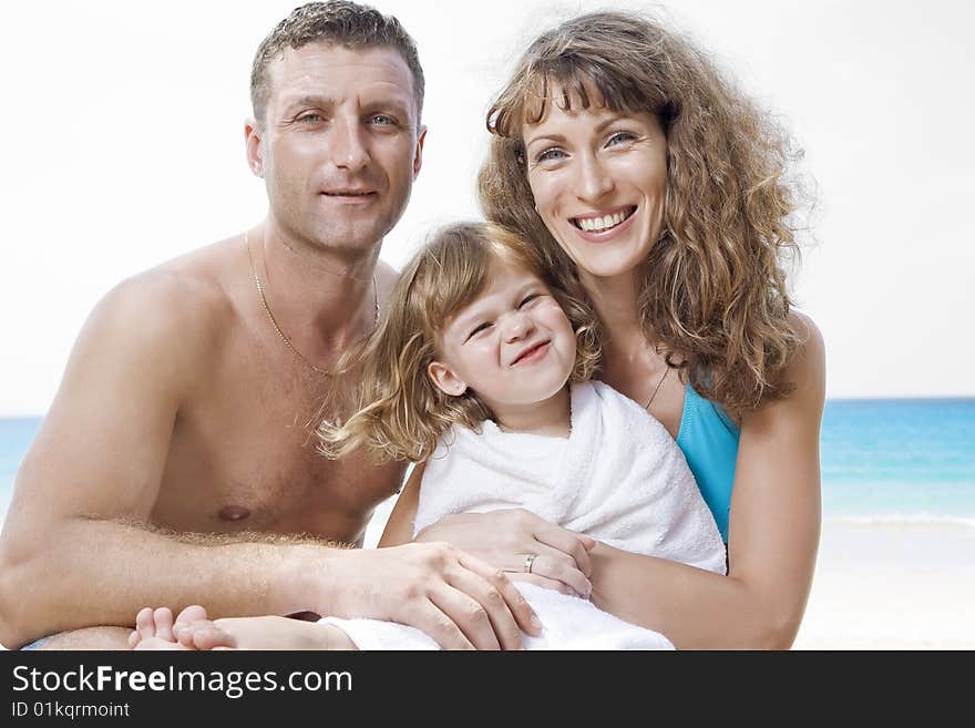 Portrait of young family having fun on the beach. Portrait of young family having fun on the beach