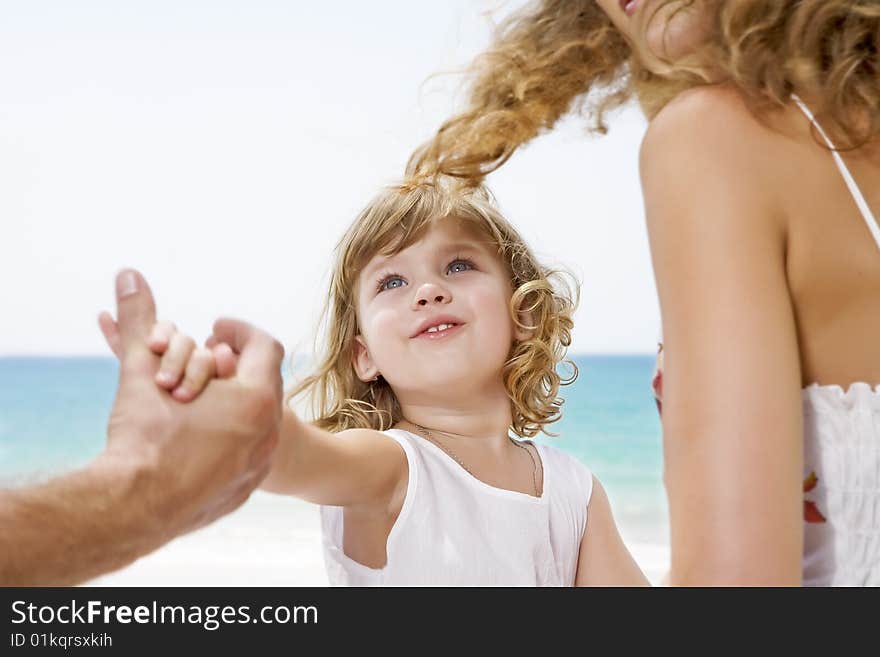 Fragment like view of young family having fun on the beach. Fragment like view of young family having fun on the beach