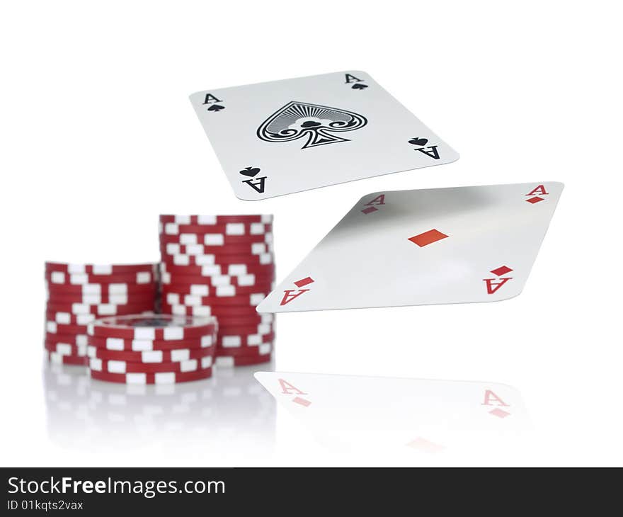 Two aces flying over a game table beside three piles of red chips. Isolated on white. Two aces flying over a game table beside three piles of red chips. Isolated on white.