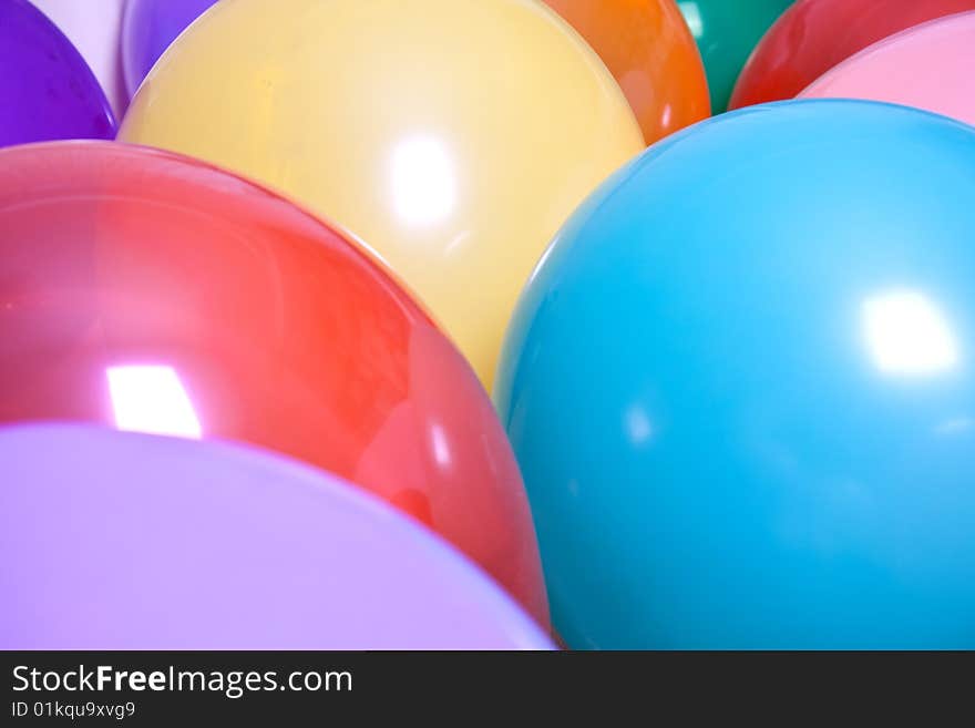 Party balloons are a group on the floor as a background