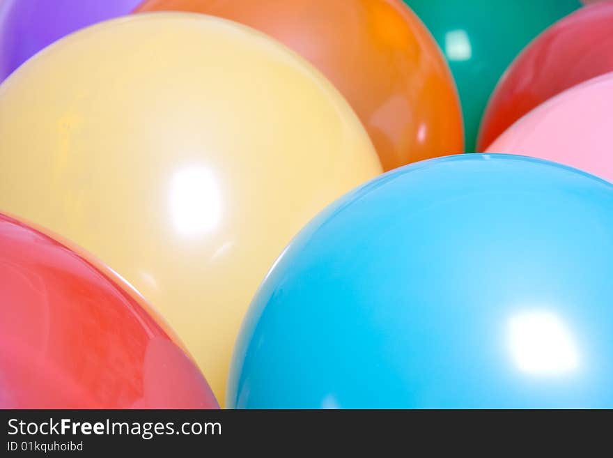 Party balloons are a group on the floor as a background