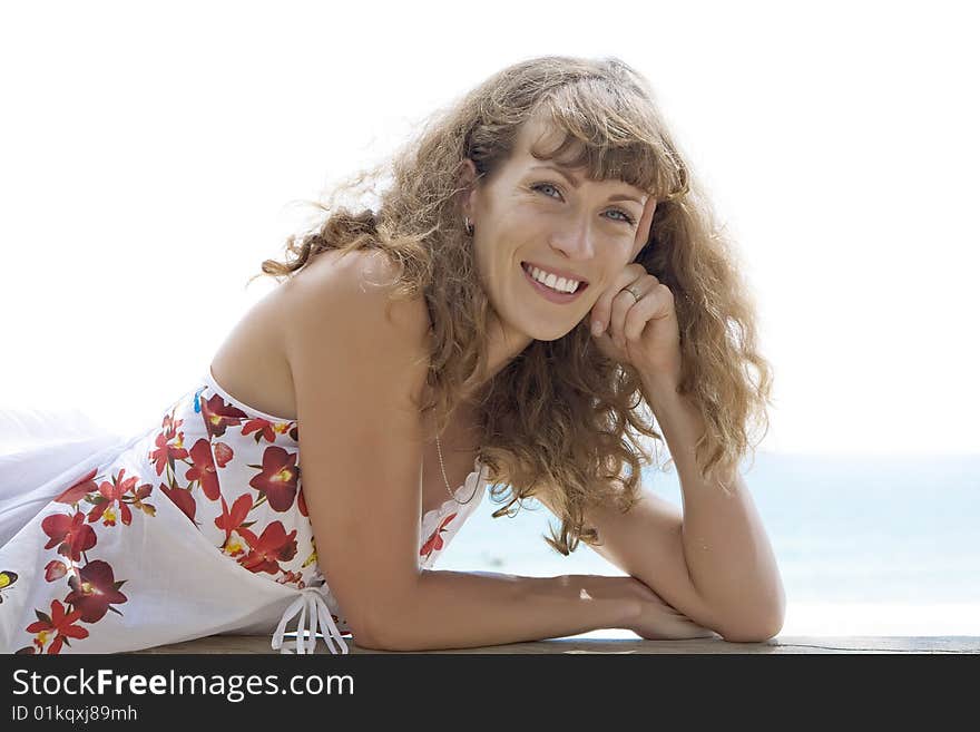 Portrait of nice young woman having good time on the beach. Portrait of nice young woman having good time on the beach